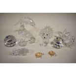 A collection of Swarovski crystal figures to include; flower, Dolphin, Hedgehog and Poodle.