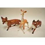 Two Beswick standing fox 1016A, including black tip to tale example and a Giraffe foal Af.