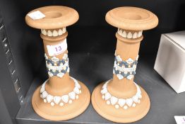 A pair of silicon ware candlesticks circa 1880, having blue and white detailing to beige ground,