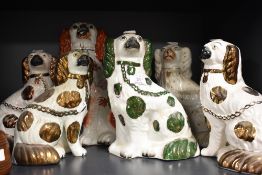 A group of six Victorian Staffordshire pottery spaniels, including one pair and one green and puce