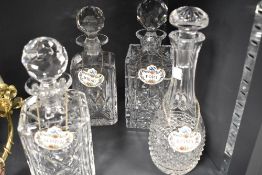 Four cut glass decanters, each having a Crown Staffordshire china spirit label; Scotch,Brandy,Port