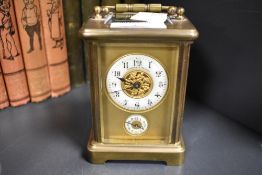 A late 19th century French brass striking carriage clock having bevelled glass sides and gallery,