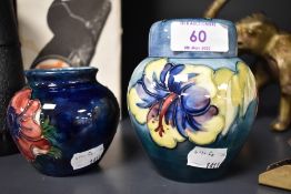 A Moorcroft Ginger jar having Hibiscus pattern on pale blue ground and a Moorcroft vase with anemone