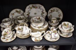 A part Aynsley tea service comprising cups and coffee cans and saucers, plates, jug and bowl, made