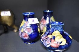 A pair of Moorcroft Pottery 'Anemone' pattern baluster vases, tube-lined with flowers against a