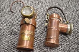 Two early 20th century copper and brass miners battery operated torches, one having name label of '