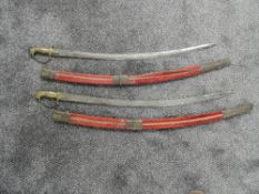A pair of Indian Hangers (swords) with scabbards, both with lion head pommels & single edge