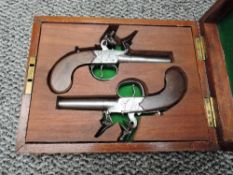 A boxed set of two small Flintlock Pistols possibly pocket or Muff Pistols by Forth of York, with