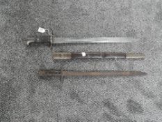 A Martini Henry Sawback Bayonet for use by the Royal Artillery 1875 with leather scabbard, marked