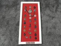 A framed display of Military Cap Badges for the Rifle Brigade including 1st North Riding Rifle