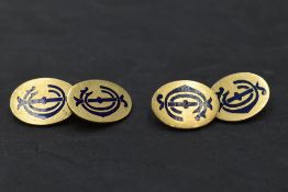 A pair of yellow metal cufflinks stamped 18ct, of oval form bearing blue enamel monograms, with