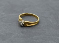 A diamond solitaire dress ring, approx 0.065ct in an illusionary mount to moulded shoulders on a