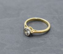 A diamond solitaire dress ring, approx 0.60ct in a collared mount on an 18ct gold loop, size M &