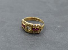 A small Victorian 18ct gold band ring having panel with diamond ruby and pearl decoration, size G/