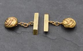 A pair of 9ct gold cufflinks having knot style decoration with chain connectors to bars,. Approx 3.