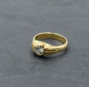 A gent's yellow metal signet ring stamped 18ct having an inset diamond, approx 1ct in a ridged