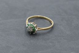 An emerald and diamond chip cluster dress ring on a 9ct gold loop, size O & 1.9g