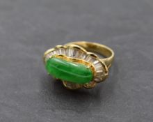 A jadeite cabouchon dress ring, approx 2.8ct within a baguette diamond set ballerina frilled