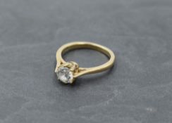 A cubic zirconia solitaire dress ring in a raised claw mount on a 9ct gold loop, size N and approx