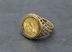 A 1/10 Krugerand dated 1984 in a 9ct gold removable ring mount, size U and approx 7.1g