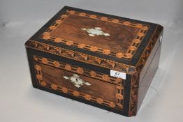 A Victorian sewing case inlayed with mother of pearl and ornate veneer case work