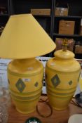 A pair of modern table lamps having decorated ceramic bodies