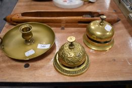 Two brass counter top bell ringers a brass chamber stick and a loom shuttle