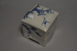 A Chinese porcelain stackable container decorated with cherry blossom tree bearing impressed seal