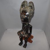 An ethnic wood hand carved African fertility figure and a traditional war club