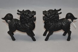 A matching pair of bronze cast temple dogs or Fu dogs both in standing positions