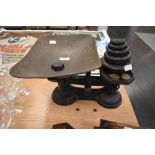 A set of cast iron kitchen balance scales with weight set