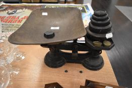 A set of cast iron kitchen balance scales with weight set