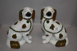 A pair of early 20th century Staffordshire flat back dogs in a Spaniel design