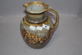 A large studio pottery water jug having natural styled glaze by John Calver