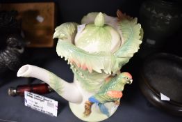 A modern figural tea pot by Franz porcelain having a parrot and jungle design