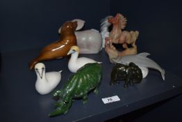 A selection of stone carved and porcelain figures including serpentine rhino and hand carved rabbit