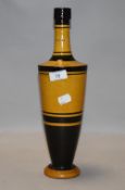 An antique Italian wine or oil bottle having black and yellow body
