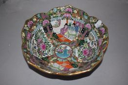 A Chinese porcelain lotus leaf design bowl in a Cantonese palette decorated with scholar scenes