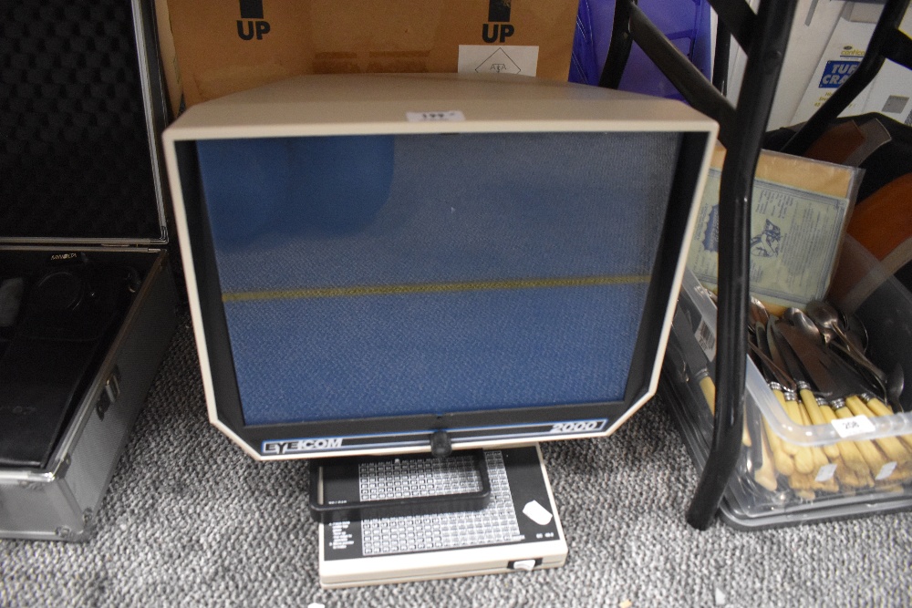 An Eyecom 2000 desktop microfische reader with box.