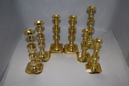 Three pairs of antique brass candle sticks in traditional designs