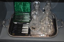 Four clear cut glass decanters one bearing name badge with plated tray and two sets of mother of