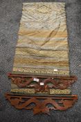 A piece of woven Indian fabric having carved wood dragon form handles