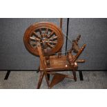 A 20th century traditional wool spinning wheel having turned oak frame