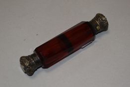 A Victorian cranberry glass two compartment salts container having cut sides with screw and cap