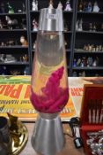 A large size polished steel and pink wax lava lamp