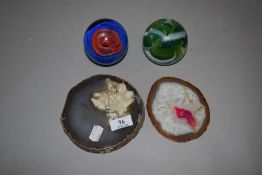 Two cross sections of semi precious stone geodes and two art glass paper weights