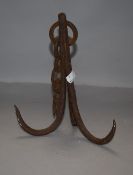 An antique wrought iron grappling hook