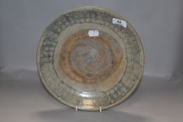 A late 17th century Chinese Kwan Tung provincial ware plate, with Celedon type glaze.