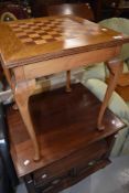 A vintage mixed wood occasional table having chequer board top