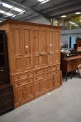 An impressive stripped pine kitchen utility cupboard having under and over cupboards with drawer